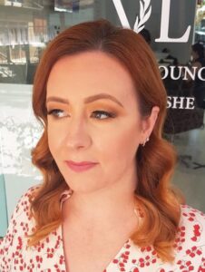 A woman with red hair looks phenomenal after Vlushe Lounge blowdry