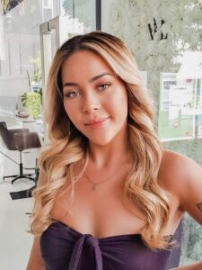 A woman with long blonde hair looks confident after Vlushe Lounge blowdry service