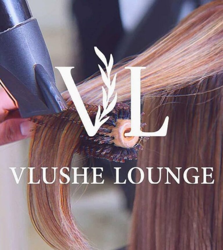 A brunette with long hair getting a blow dry by Vlushe Lounge stylist